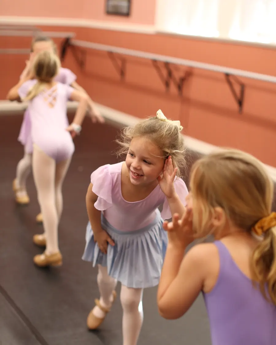 A young Elevate dancer laughing mid class in the studio
